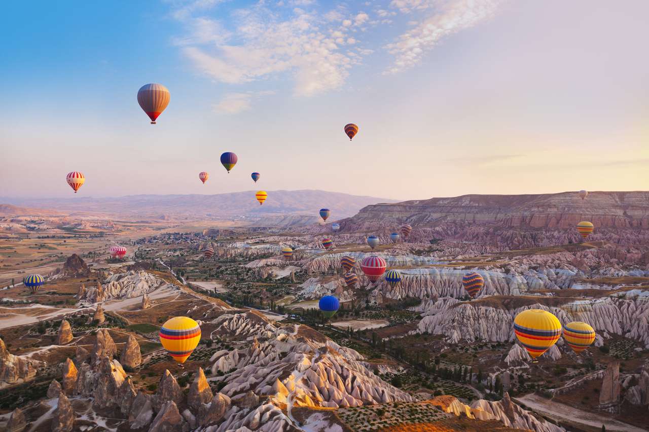 Hot air balloon flying over rock landscape online puzzle