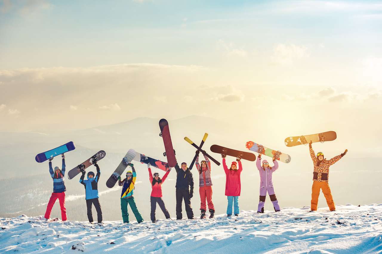 Skiers and snowboarders on mountain top jigsaw puzzle online