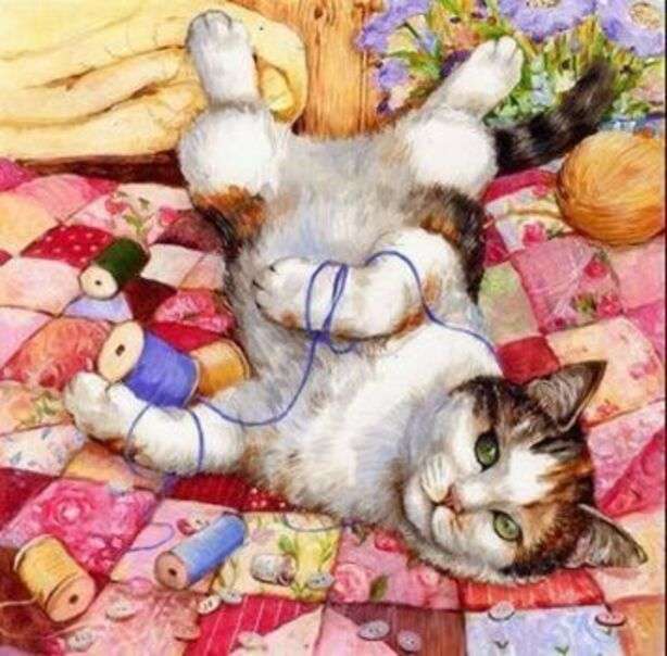 Gatito jugando con hilos en la cama rompecabezas en línea