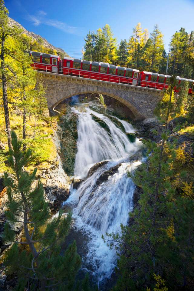 Swiss electric trains pass mountain alpine gorges online puzzle