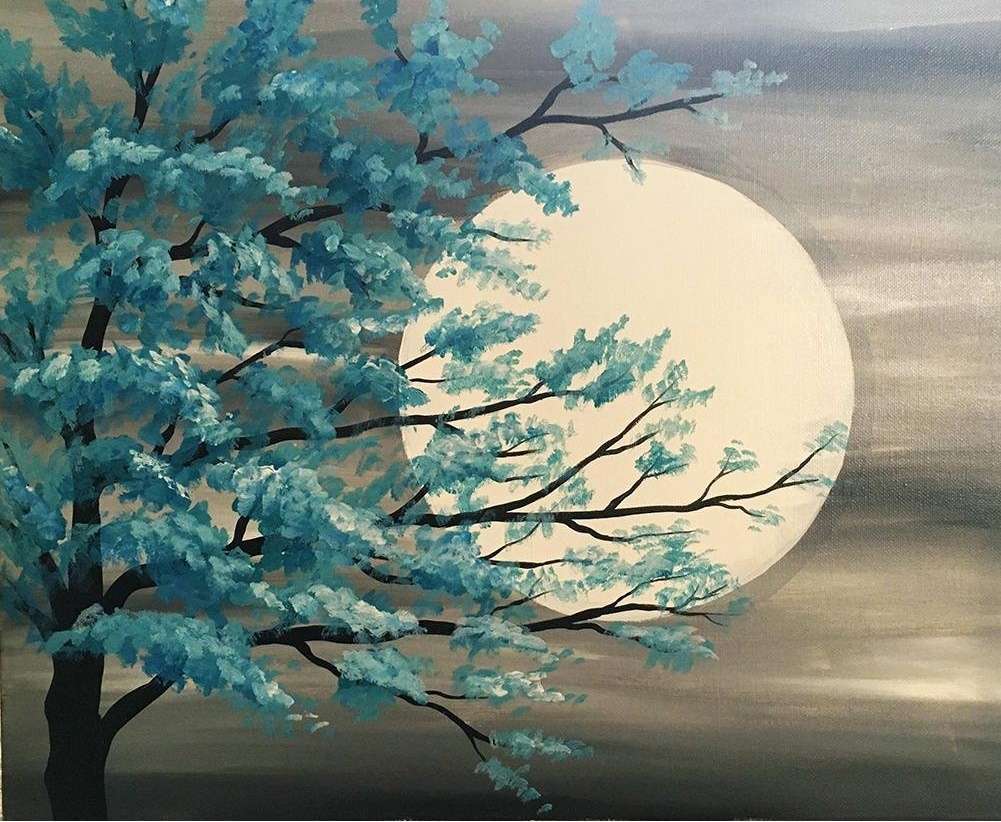 the moon behind the tree branches jigsaw puzzle online