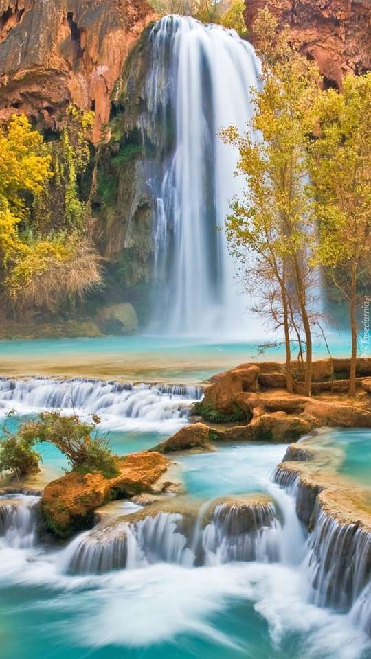 A waterfall and large stones jigsaw puzzle online