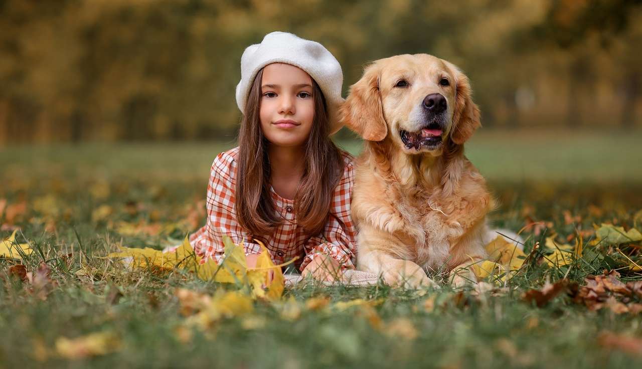 Little girl with a dog in the autumn park online puzzle