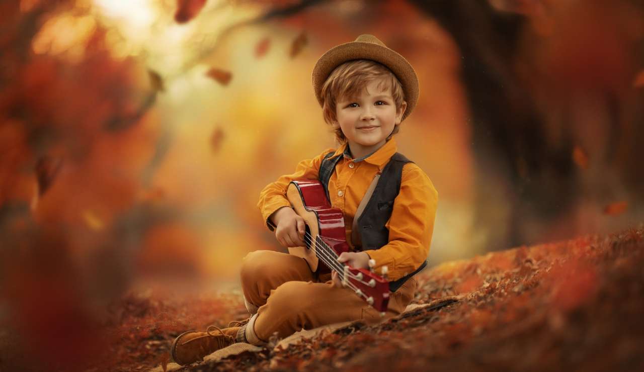 Boy in a hat playing the guitar jigsaw puzzle online