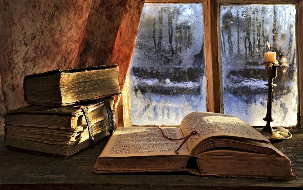 Old books and a candle and winter outside the window online puzzle