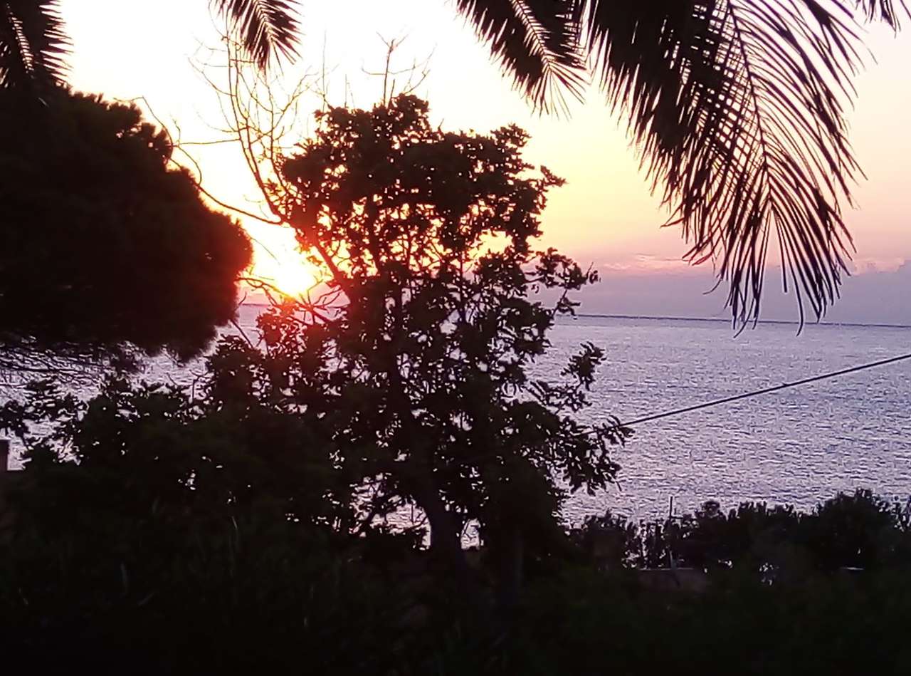 Pôr do sol em Porto Corallo quebra-cabeças online