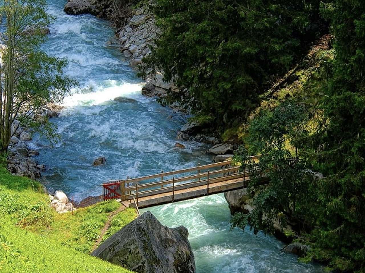 Uma pequena ponte sobre um rio caudaloso, uma vista encantadora quebra-cabeças online
