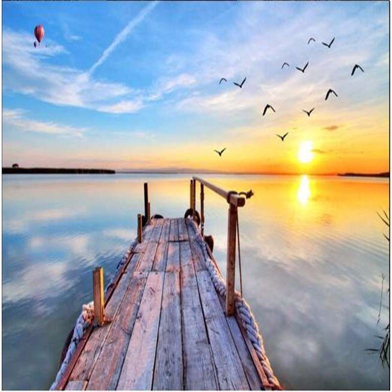 Lake with a footbridge at sunset online puzzle