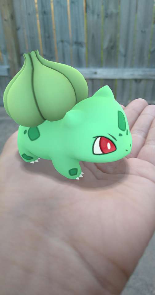 En grön Pokémon blir älskad på en hand! Pussel online