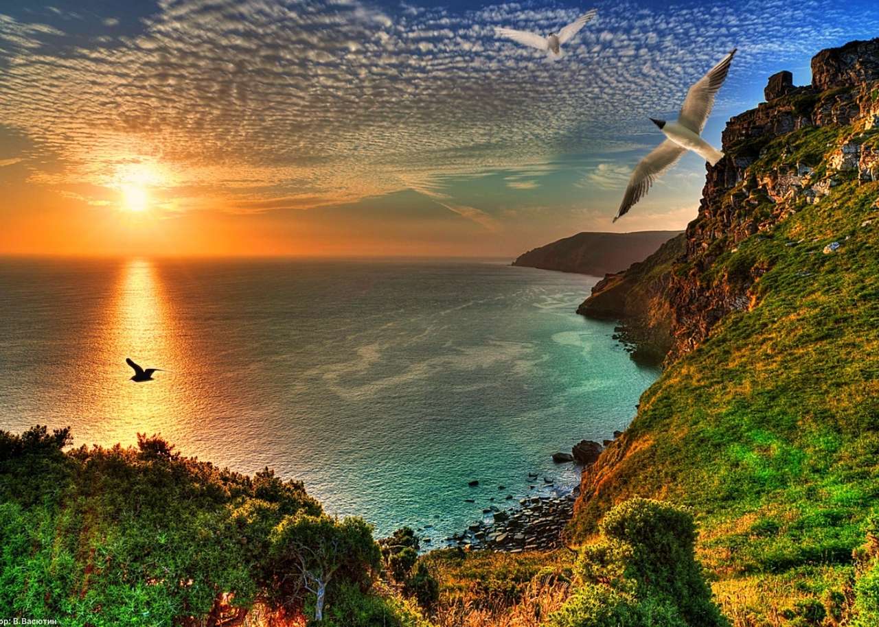 Felsige Küste bei Sonnenuntergang Puzzlespiel online