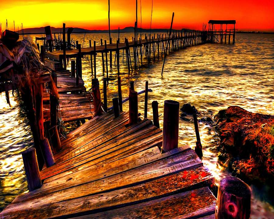 De golven raasden over de gesloopte pier, een prachtige zonsondergang legpuzzel online