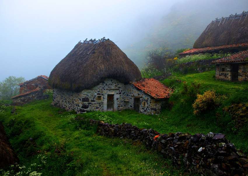 Very old mountain huts and fog in the mountains jigsaw puzzle online