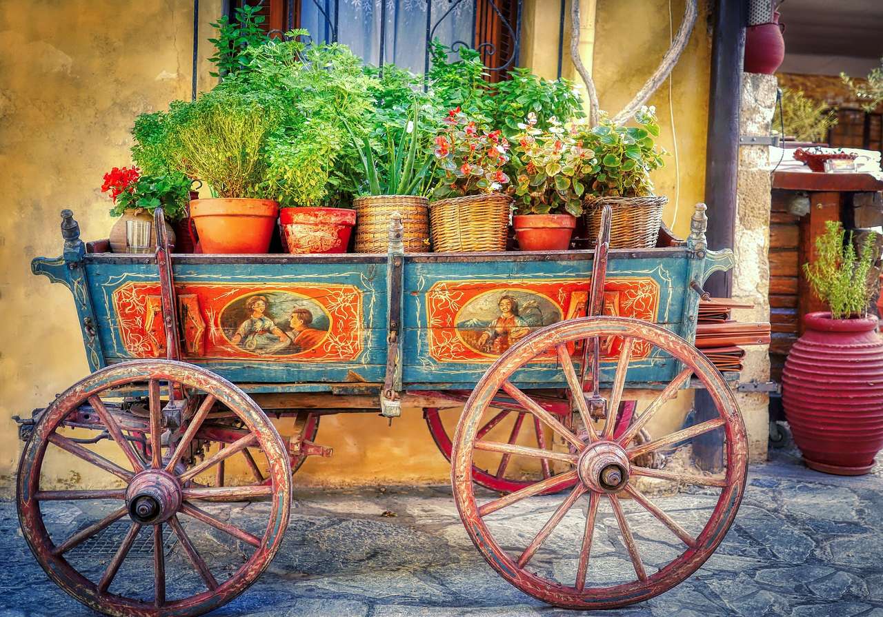 Um carrinho de ervas e cardápios no jardim do restaurante puzzle online