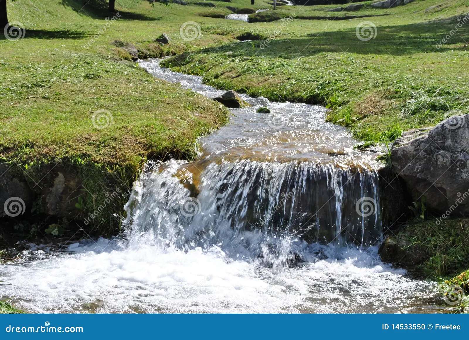 A small waterfall on a stream jigsaw puzzle online