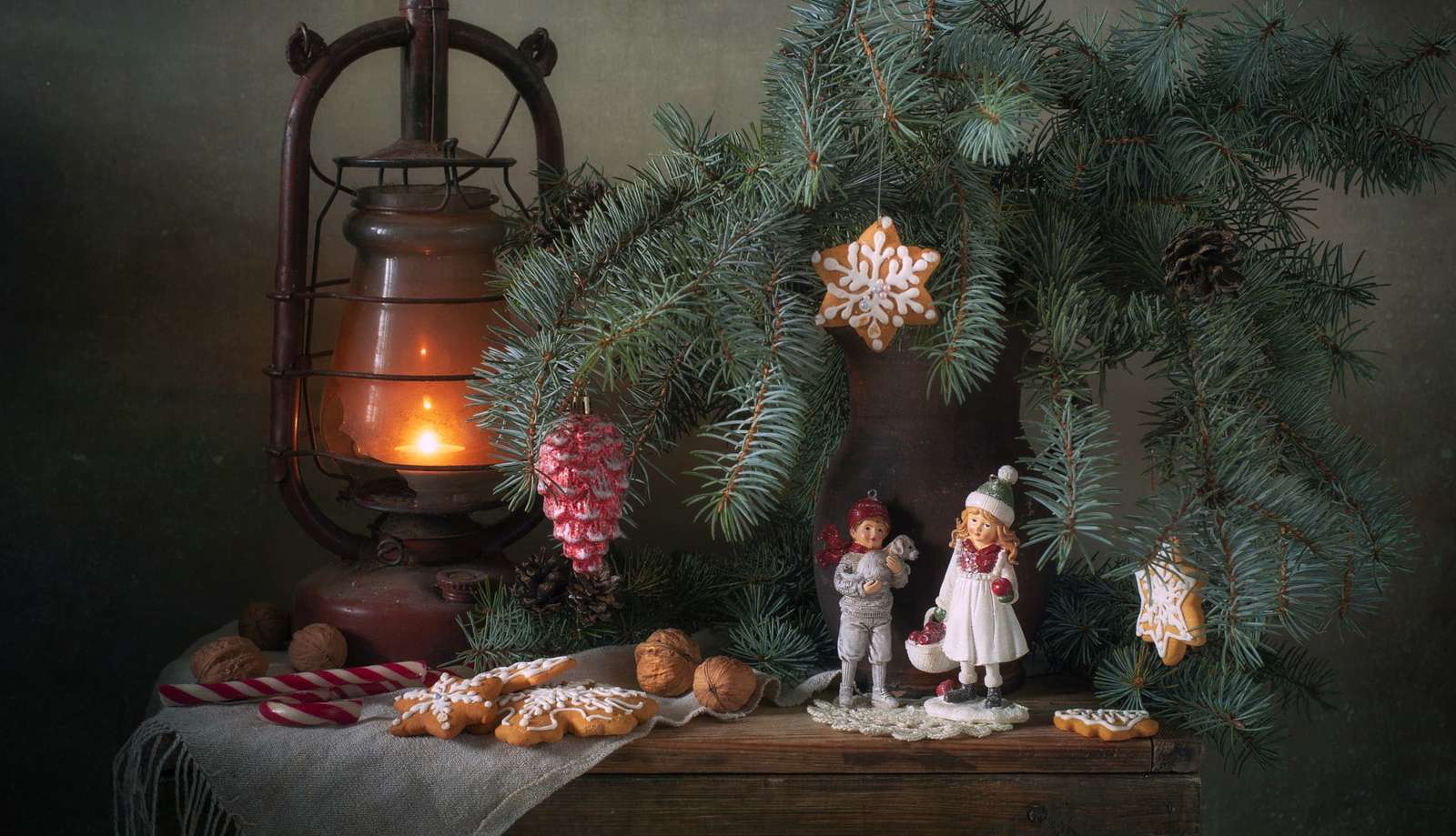 figurines with a lamp next to spruce branches jigsaw puzzle online