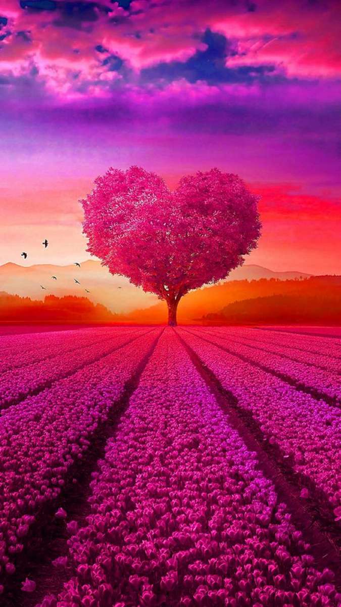 bel arbre de coeur sur un pré rose au coucher du soleil puzzle en ligne