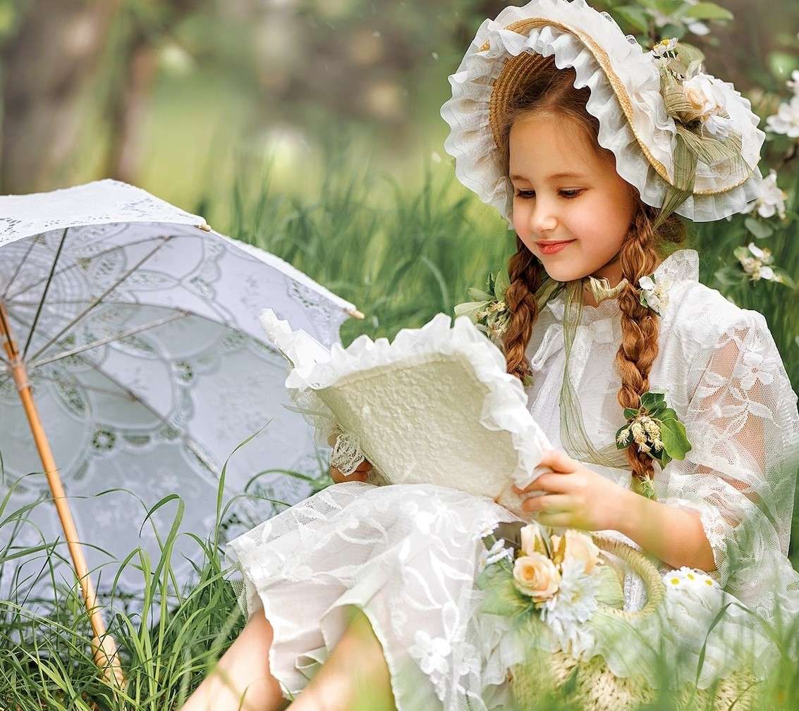 A girl with a book in the meadow jigsaw puzzle online