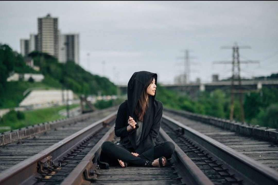 A girl sitting on the railway tracks jigsaw puzzle online